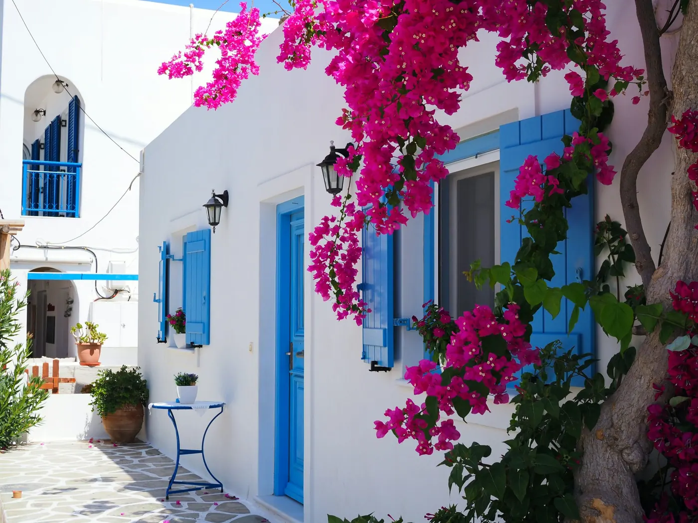 A Greek island home framed by bougainvillea